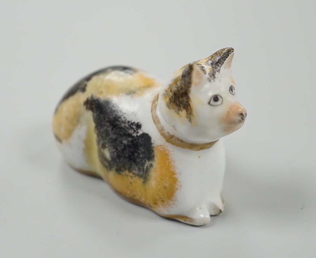 A rare small Staffordshire porcelain figure of a recumbent cat, c.1830-50. 6cm long, Cf. Dennis G.Rice Cats in English porcelain, colour plate 54., Provenance: Dennis G.Rice collection